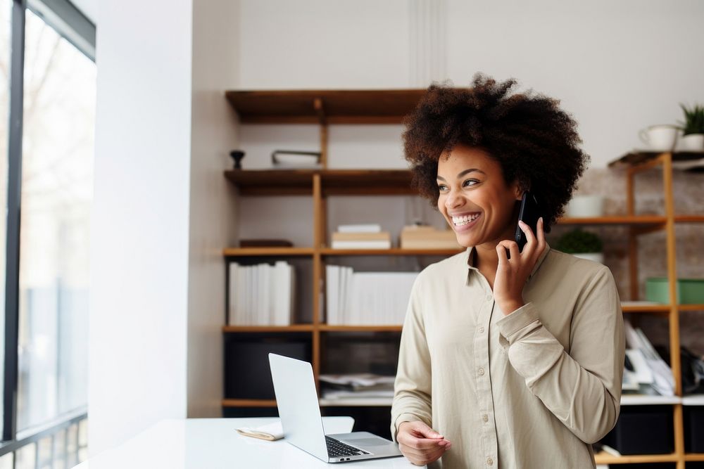 Smiling African entrepreneur computer standing looking. 