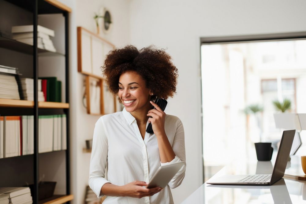 Smiling African entrepreneur standing computer looking. AI generated Image by rawpixel.