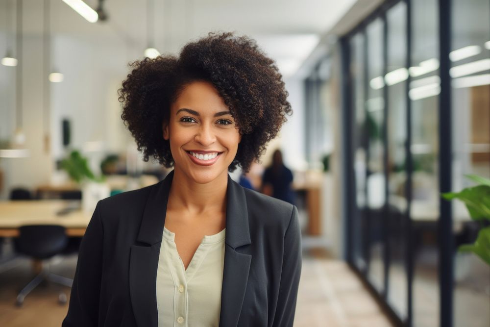 Happy african woman smiling portrait standing office. 