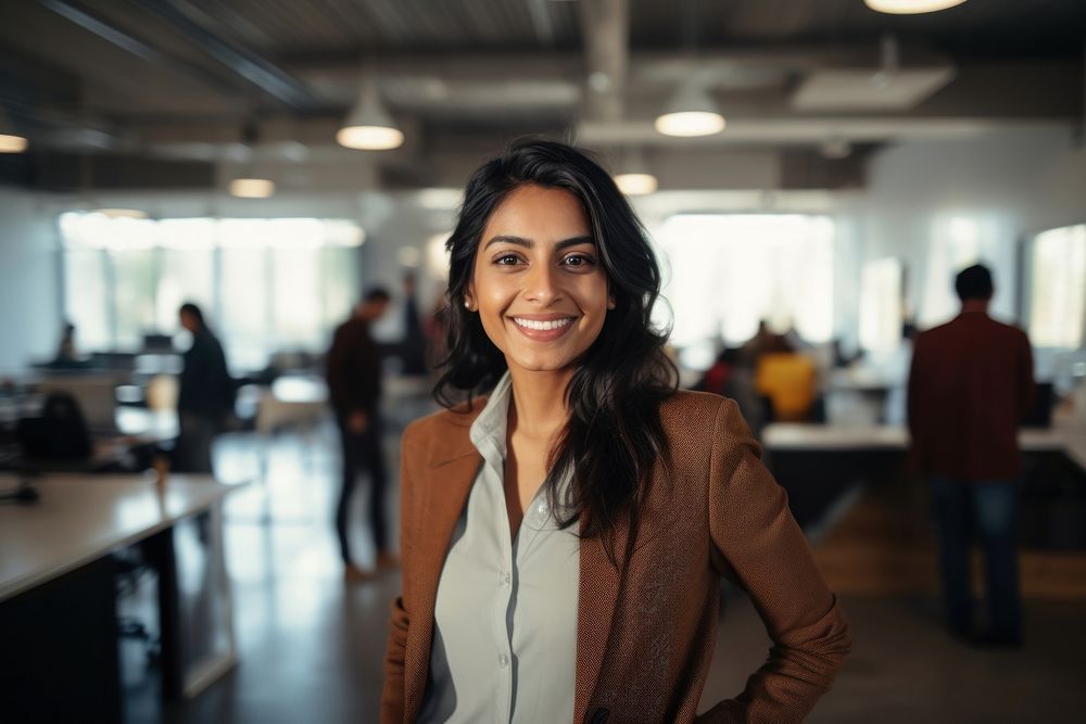 Happy indian woman smiling portrait standing office. 