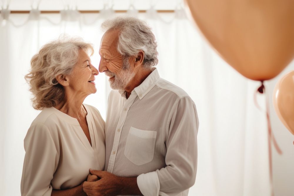 Senior couple celebrating birthday together balloon adult affectionate. 