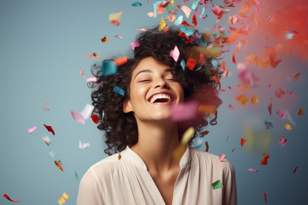 Woman blowing confetti laughing adult celebration. AI generated Image by rawpixel.