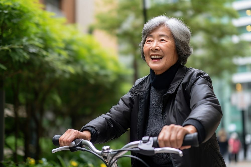 Senior asian woman riding a bicycle vehicle smile adult. 