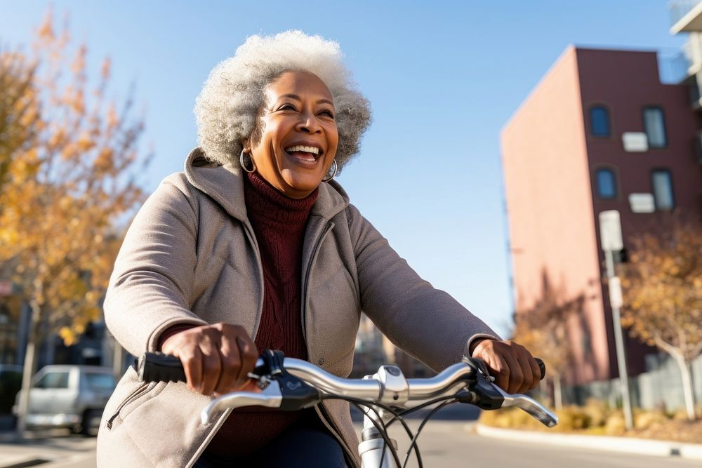 Senior black woman riding a bicycle smile adult transportation. 