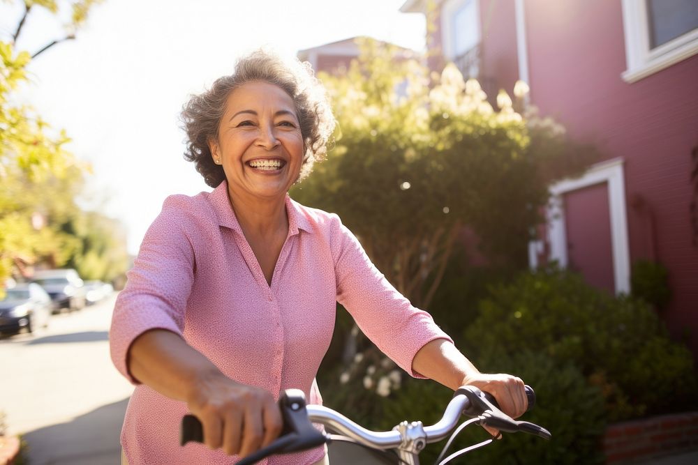 Senior hispanic woman riding a bicycle vehicle smile adult. AI generated Image by rawpixel.