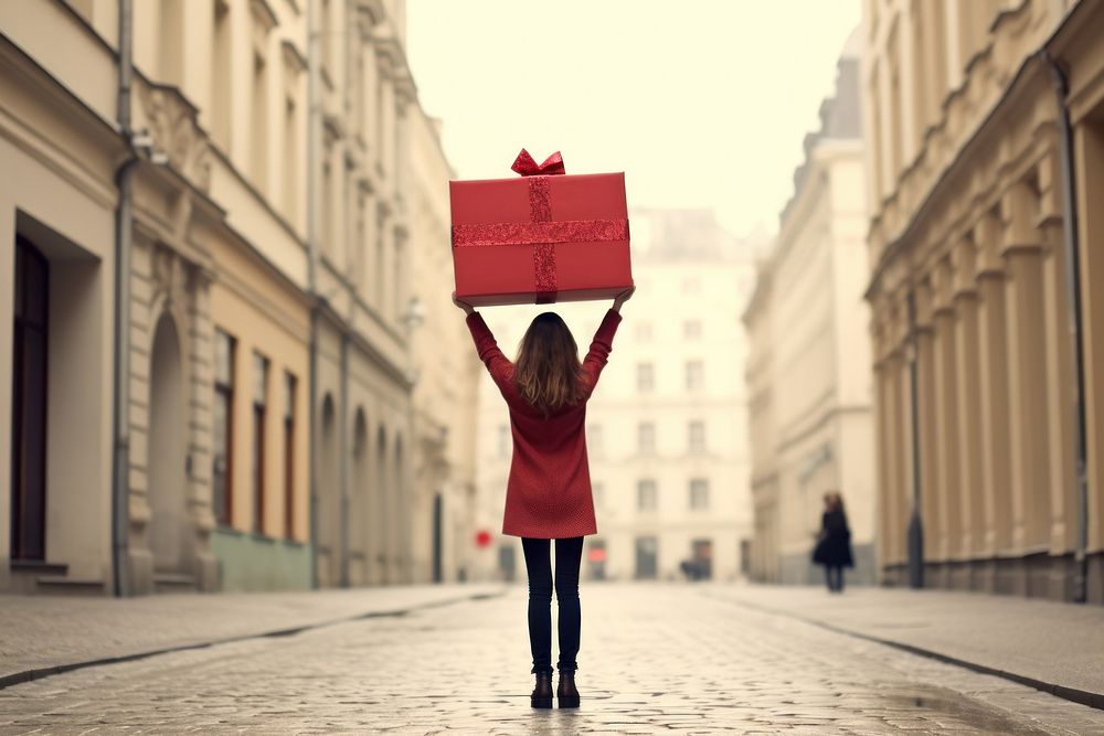 Woman carrying large present box, design resource. AI generated Image by rawpixel