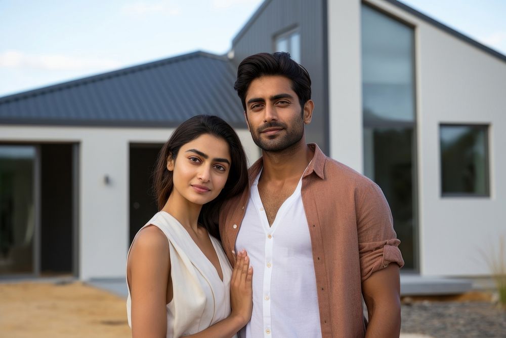 Indian couple standing adult house. 