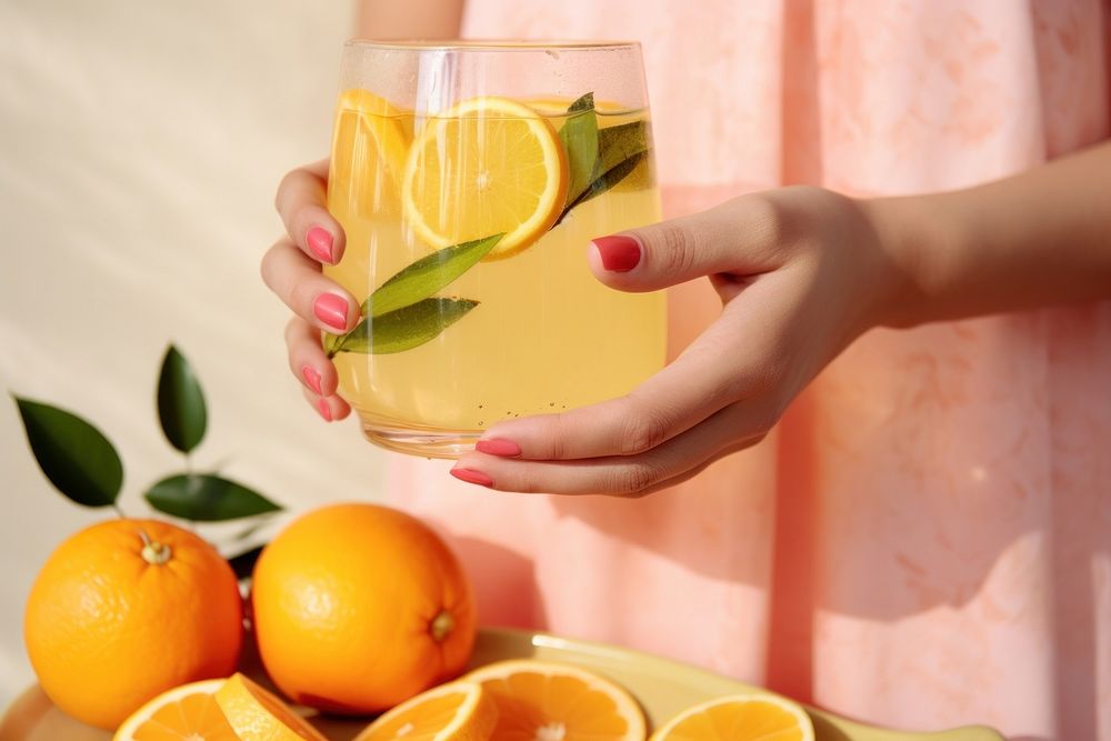 Woman holding fruit infused water, close-up photo. AI generated image by rawpixel.