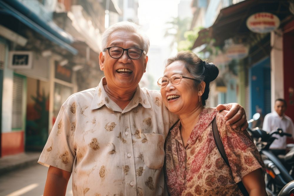 Old asian couple laughing smiling glasses. 