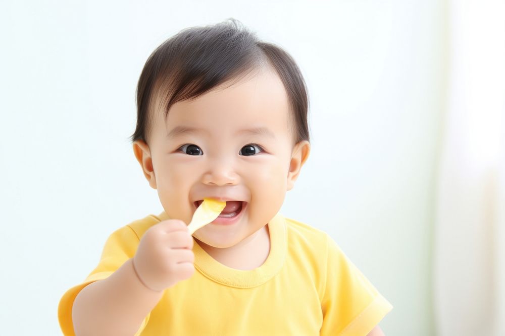 Baby eating biting food innocence. AI generated Image by rawpixel.