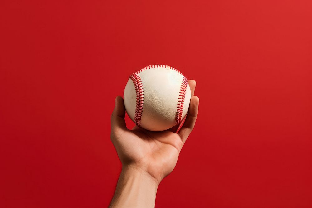 Hand holding baseball, red background. AI generated image by rawpixel.