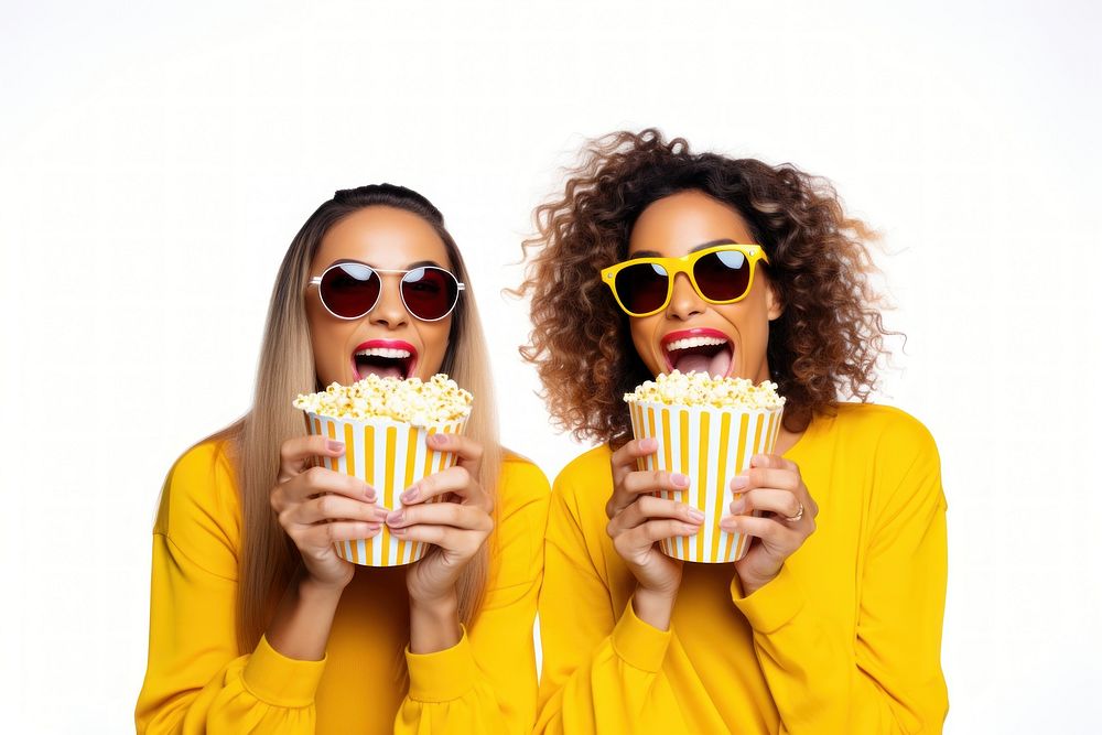 Two young women eating popcorn while watching movie together cup white background togetherness. AI generated Image by…