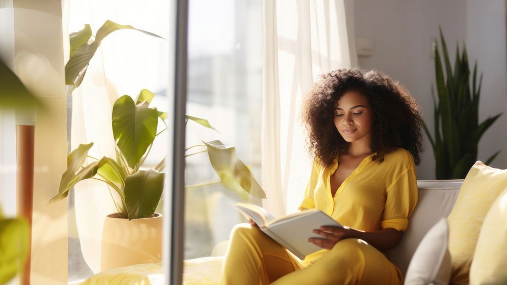 Photo of A relaxed trendy mixed-race african middle aged woman with long wavy hair with book. AI generated Image by…