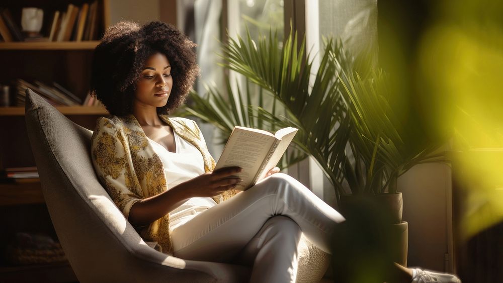 Photo of an african women wearing casual clothes reading book on an armchair, modern livingroom. AI generated Image by…