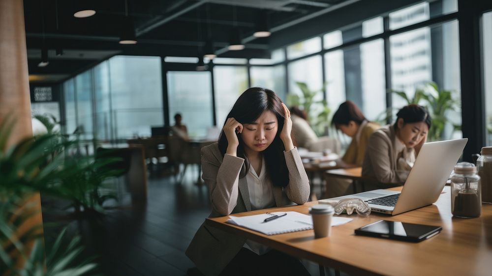 Photo of middle age asian office women having a bad day at office. AI generated Image by rawpixel. 