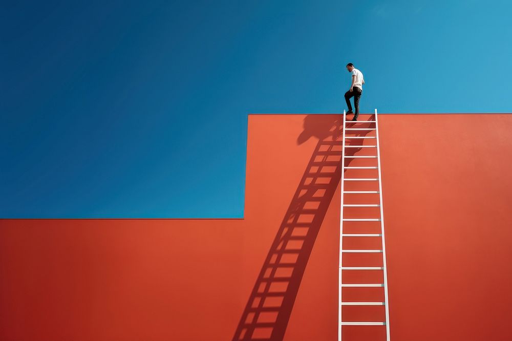 Photography of a man climbing a ladder to the roof.  