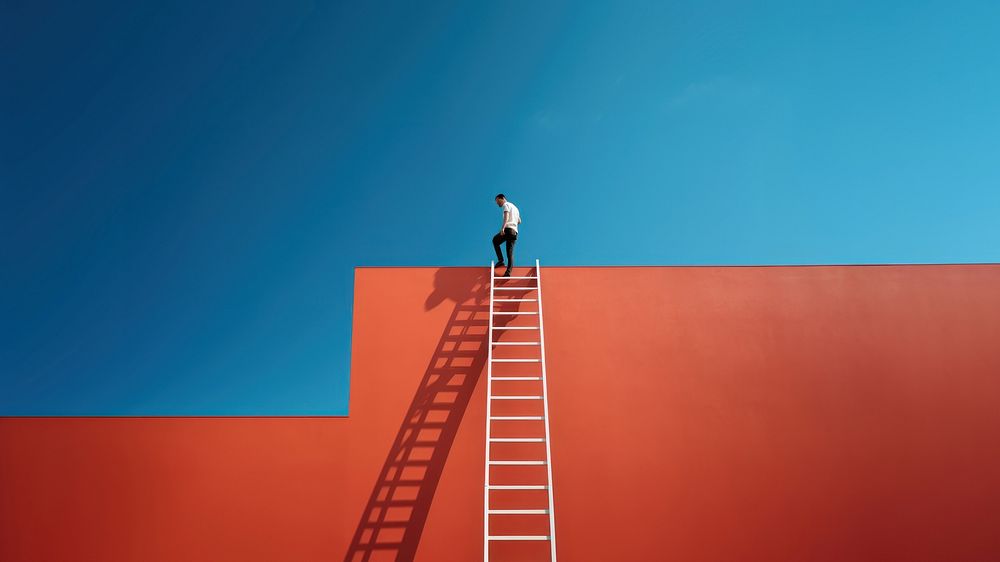 Photography of a man climbing a ladder to the roof.  