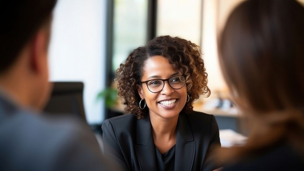 close up photo of a black middle age female lawyer with clients. AI generated Image by rawpixel. 