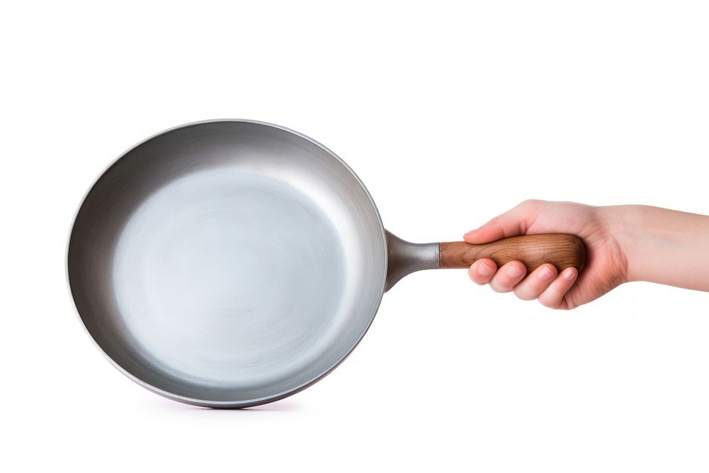 Hand holding pan wok white background silverware. AI generated Image by rawpixel.