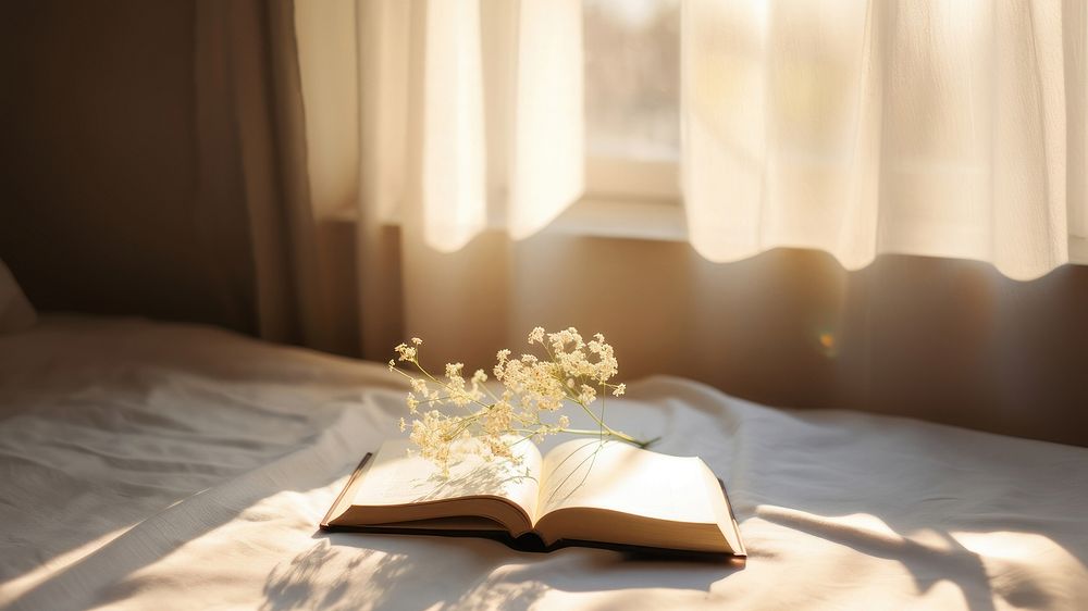 minimal photo of an open book sitting on top of a white sheet. AI generated Image by rawpixel. 