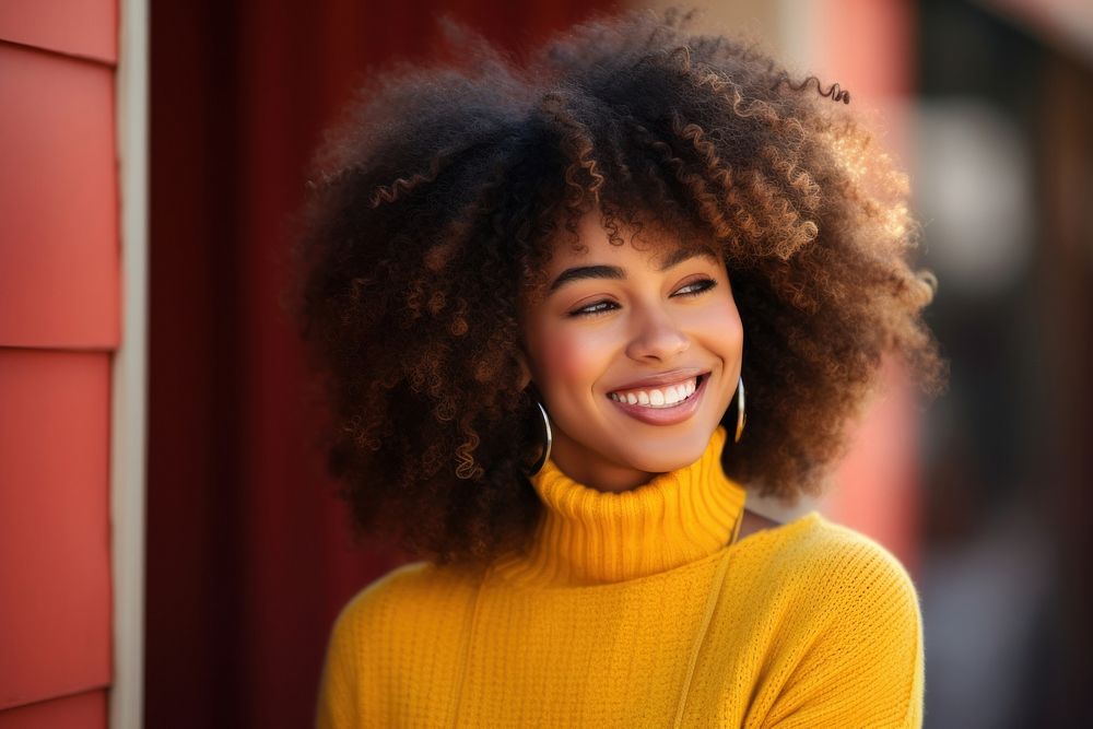 A African-American young woman smile portrait sweater. 