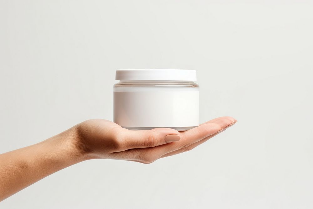 Cosmetics jar mockup Hand holding. AI generated Image by rawpixel.