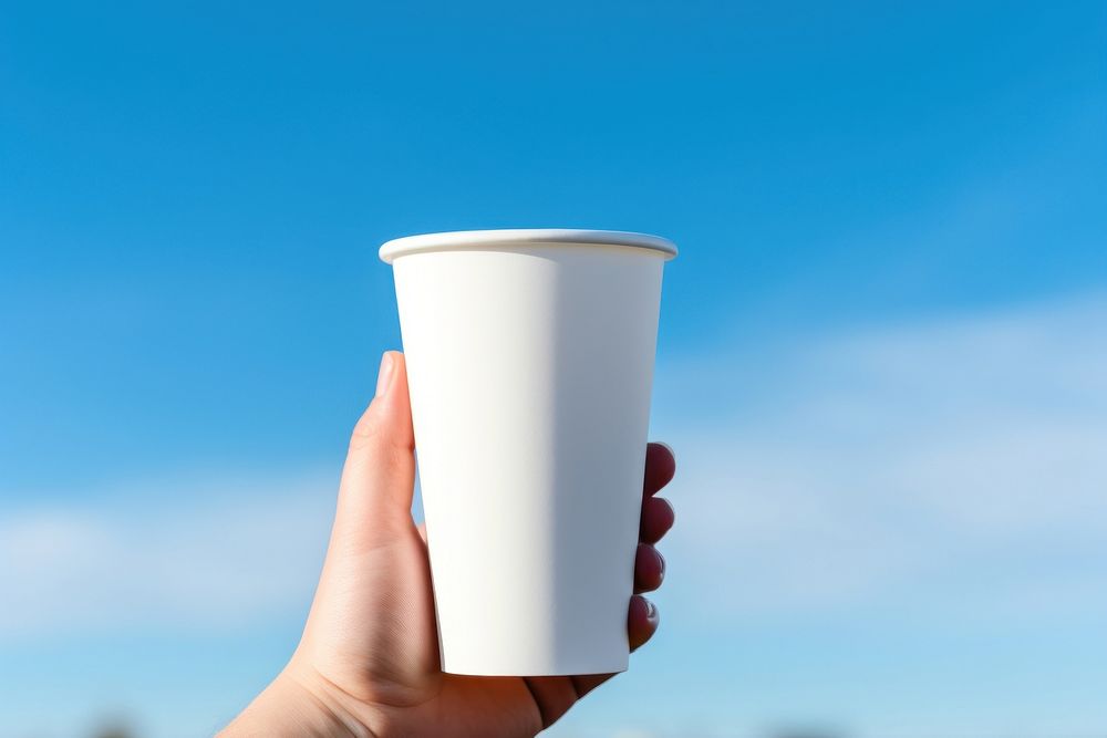 White tumbler cup holding coffee. AI generated Image by rawpixel.