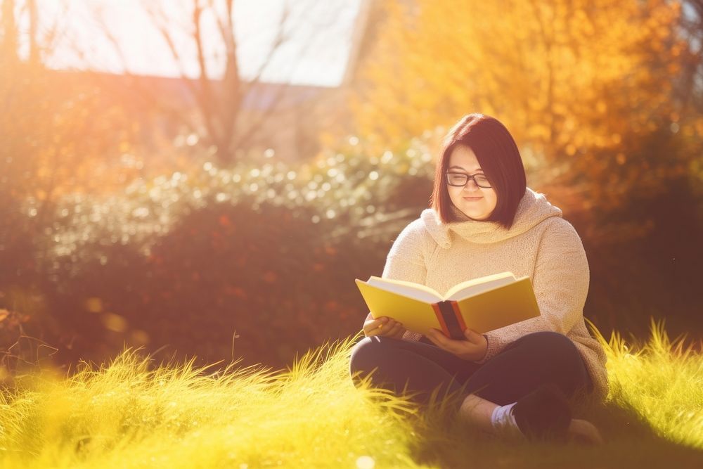 Reading a book sitting autumn grass. AI generated Image by rawpixel.