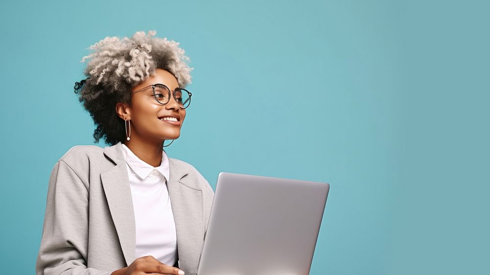 Female looking upward while reading communicating online using silver laptop. AI generated Image by rawpixel. 