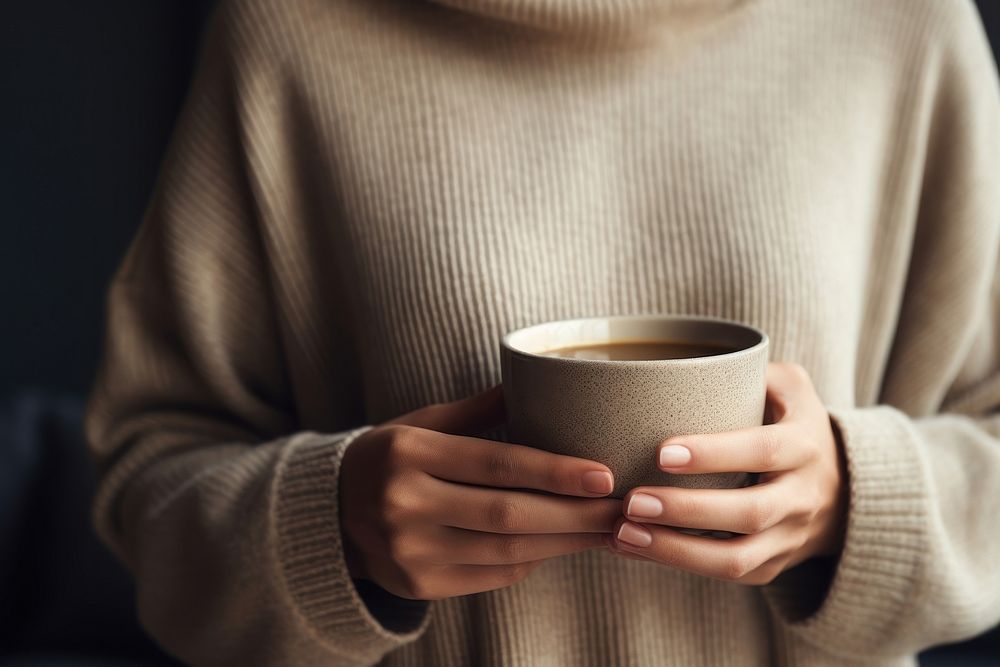 Black coffee sweater cup holding. AI generated Image by rawpixel.