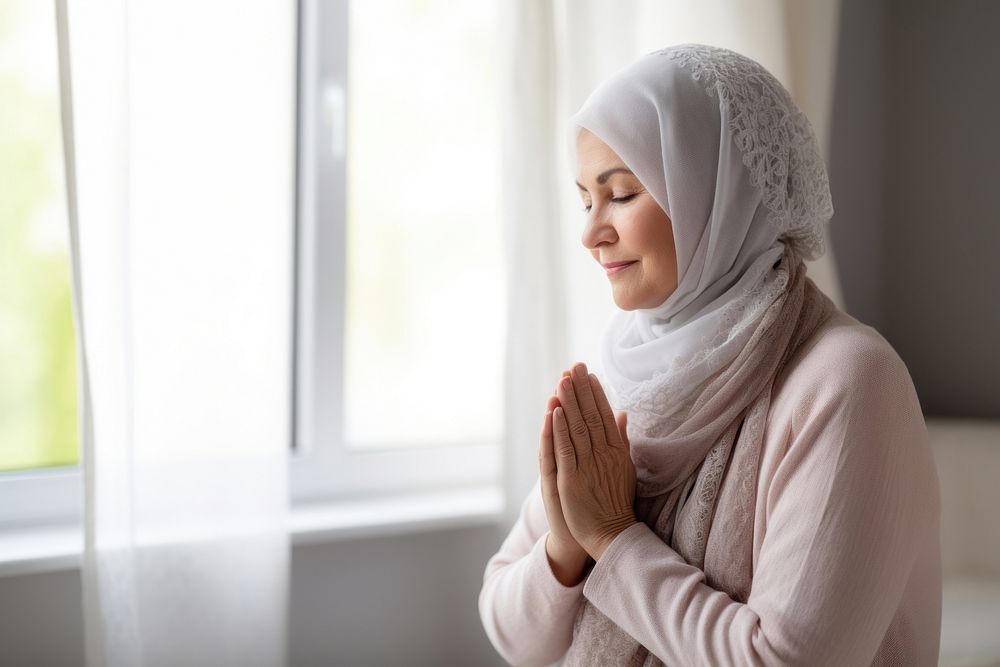 Senior woman wearing hijab praying contemplation spirituality architecture. AI generated Image by rawpixel.