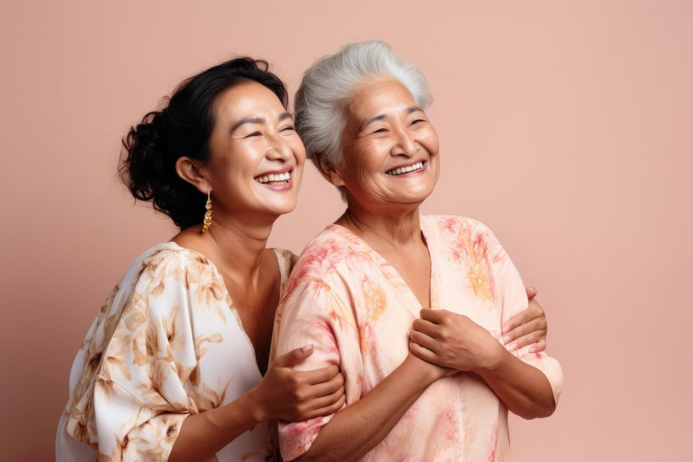 Old native women using skincare cream laughing adult togetherness. 