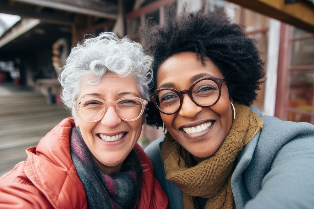 2 diverse senior women taking selfie together laughing portrait glasses. 