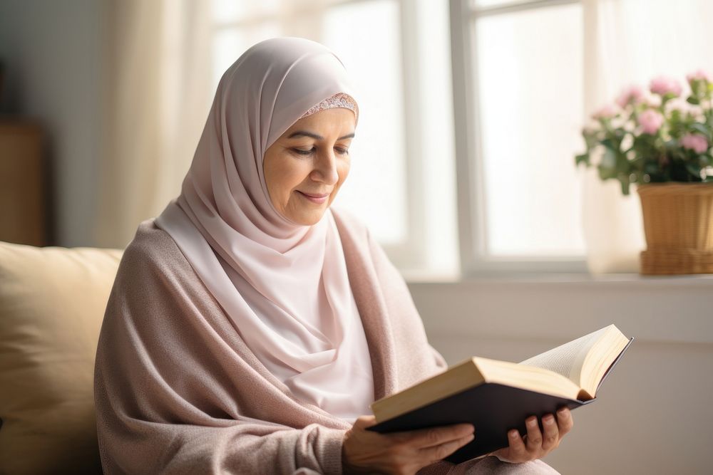 Senior woman wearing hijab reading a book adult contemplation spirituality. 