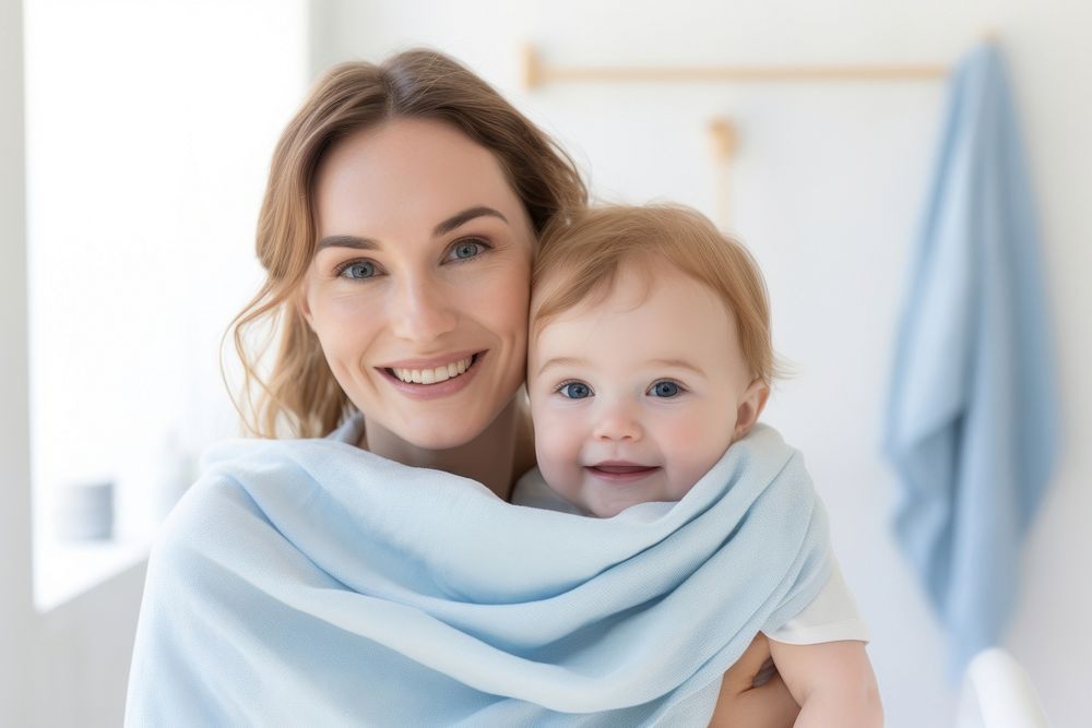 Baby wearing blue towel portrait adult happy. AI generated Image by rawpixel.