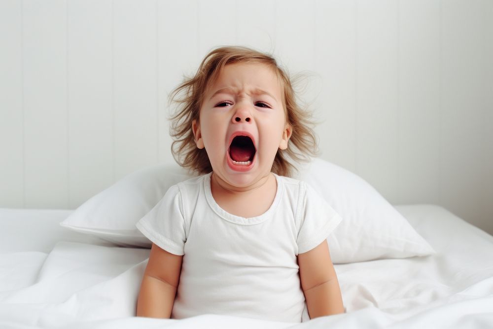 Baby yawning bed frustration. AI generated Image by rawpixel.