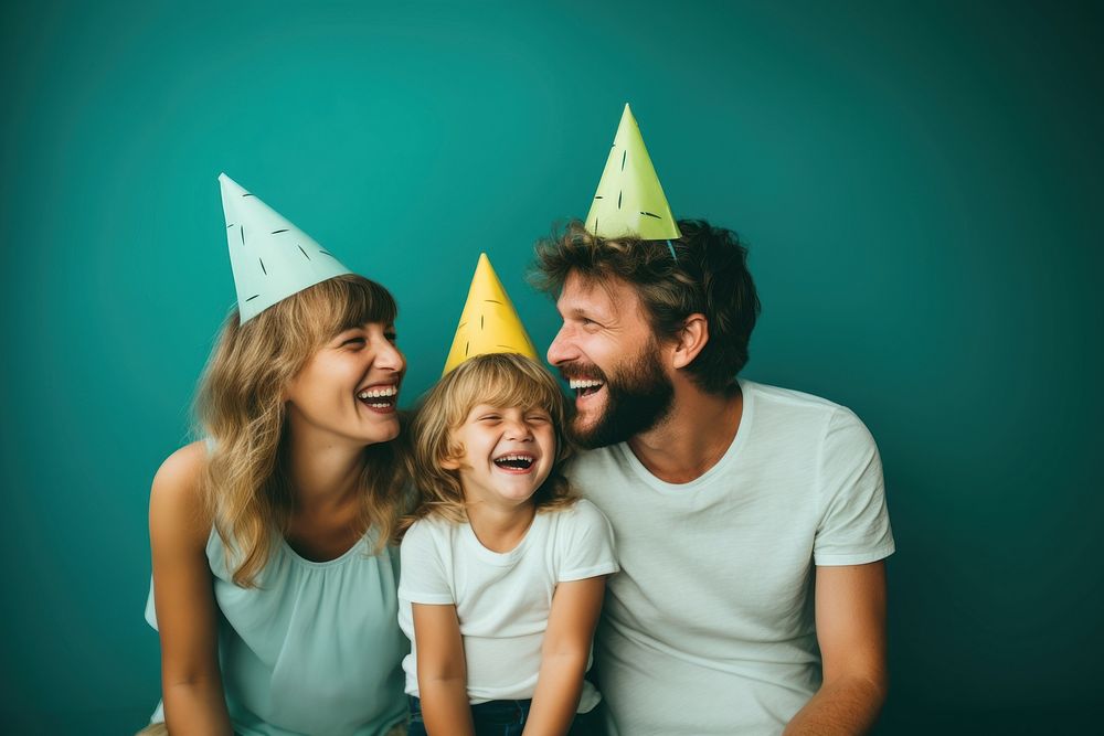 A family wearing party hat laughing portrait adult. 