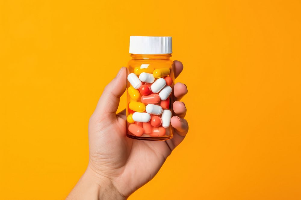 Hand holding pill bottle medical medication container. AI generated Image by rawpixel.