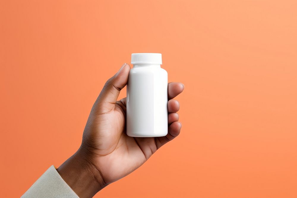 Hand holding pill bottle milk medication container. AI generated Image by rawpixel.