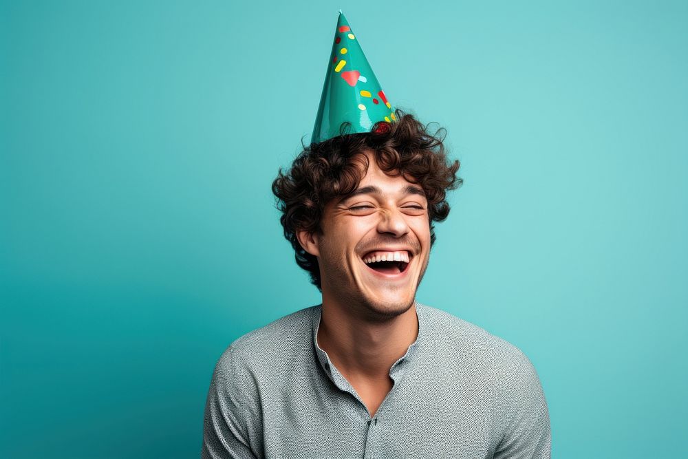 Man wearing party hat laughing adult celebration. 