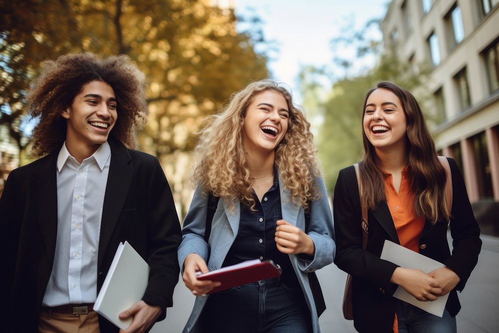 Students holding books laughing talking adult. 