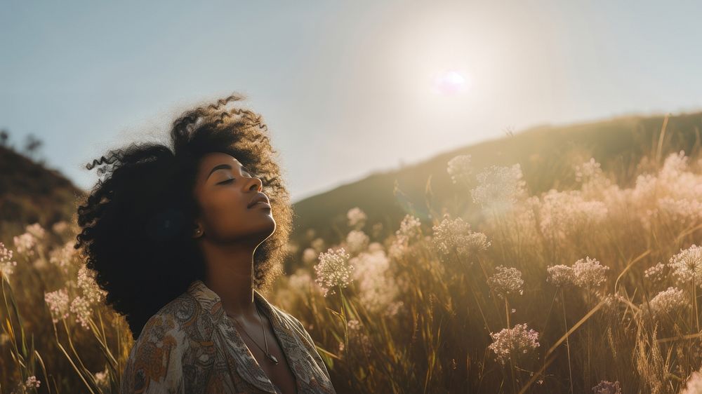 photo of happy black woman in a meadow.  