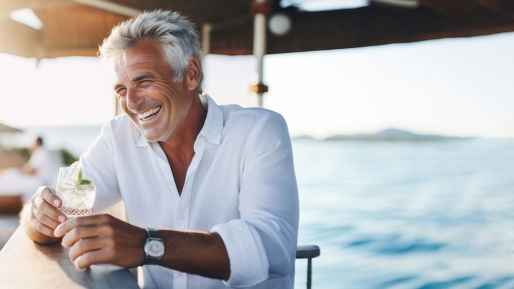 Close up photo of a middle-age men wearing white linen shirt. 