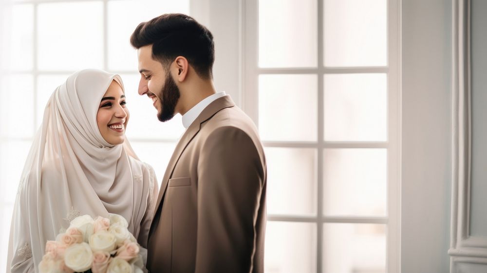 Cropped shot of muslim couple newlywed looking at each other, happy. 