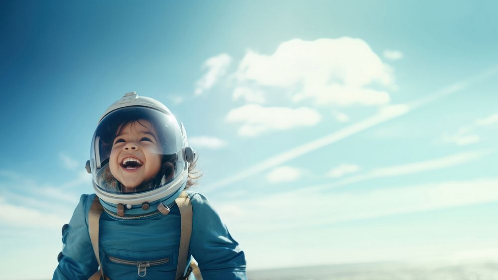 photo of smiling girl child dressed as astronaut.