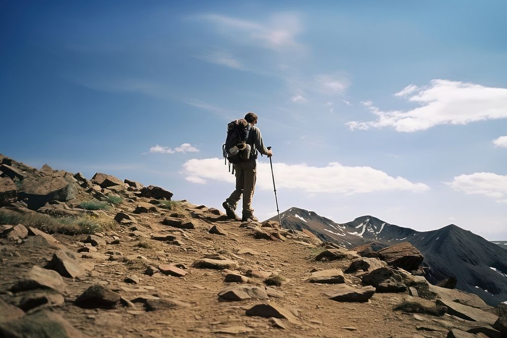 Photo of a man hiking, bright sky. AI generated image by rawpixel.