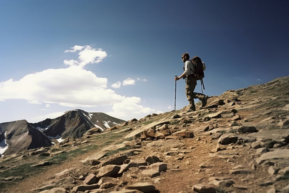 Photo of a man hiking, bright sky. AI generated image by rawpixel.