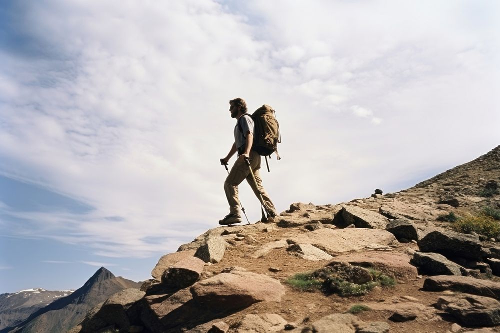 Photo of a man hiking, bright sky. AI generated image by rawpixel.