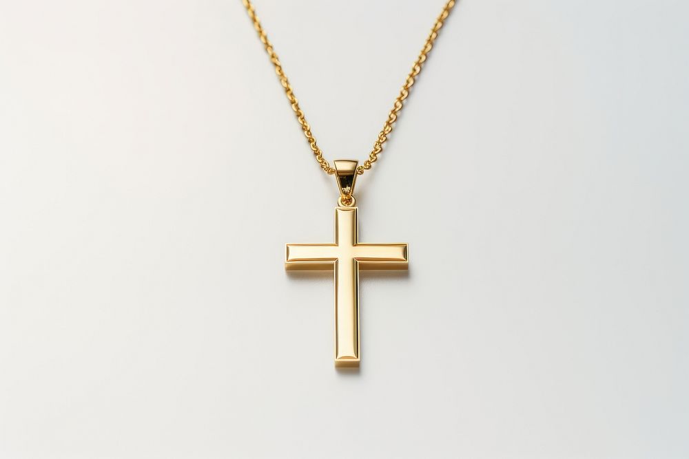 Elegant gold cross necklace on a chain. Gold cross pendant shines. Simple gold cross design. Perfect gold cross accessory…