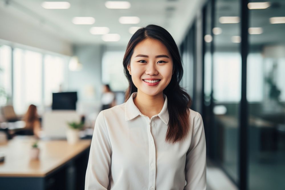 Happy asian woman smiling standing portrait office. 